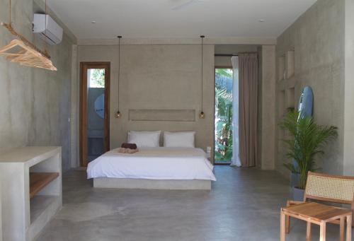 a bedroom with a bed with a dog laying on it at Dannys Madiha in Kamburugamuwa