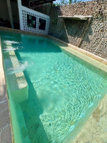 a swimming pool with blue water in a house at Casa Torices Real 12 in Cartagena de Indias