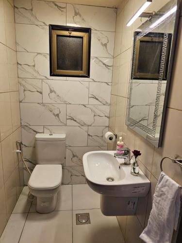 a bathroom with a toilet and a sink at 2 bedrooms apartment no 13 in Amman