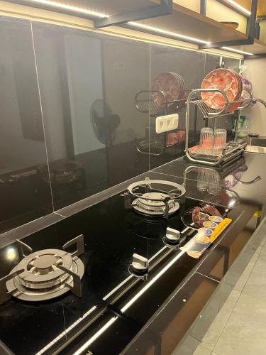 a kitchen with a stove with plates on it at ABD Home Blitar syariah at Blitar City in Blitar