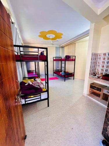 a room with three bunk beds in it with a ceiling at Vedic Hatha Vinyasa Yoga Ashram in Narendranagar