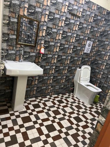 a bathroom with a sink and a toilet at Vedic Hatha Vinyasa Yoga Ashram in Narendranagar