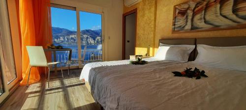 a bedroom with a large bed with a large window at Appartamenti Villa Eden in Malcesine