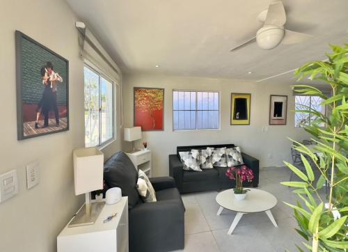 a living room with a couch and a table at Cozy House in Pipa