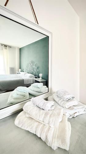 a large mirror in a bedroom with two beds at B&B San Savino in Piacenza