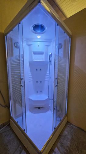 a glass room with a shower in a room at Hotel Ranavilas Palace in Jaipur