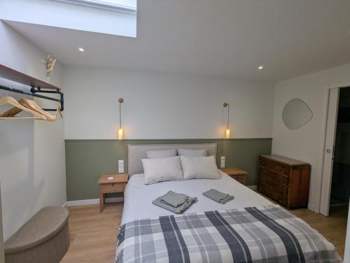 ein Schlafzimmer mit einem Bett, auf dem zwei Handtücher liegen in der Unterkunft Logement Indépendant - à proximité de Lille in Lambersart