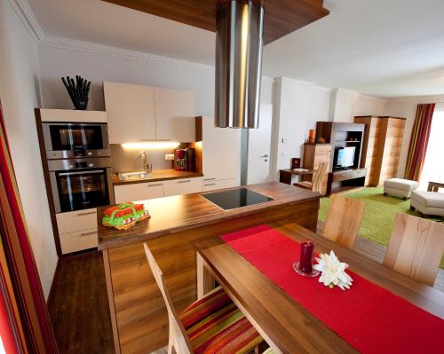 een keuken en eetkamer met een tafel en stoelen bij Parkvilla Appartements in Bad Hofgastein