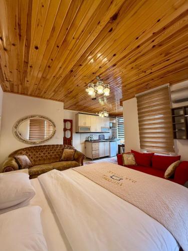 a large bedroom with a large bed and a kitchen at Isgobya Sumela Monastery 102 in Macka