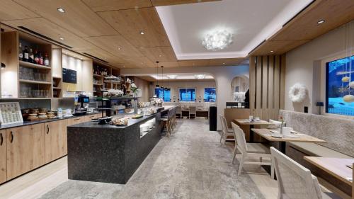 een restaurant met een bar en een aantal tafels en stoelen bij Café-Pension Erika in Pertisau