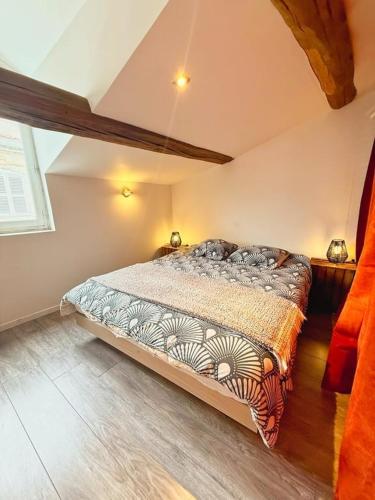 a bedroom with a large bed in a room at Coeur Rochelais, Atypique, centre, 5 min du port in La Rochelle