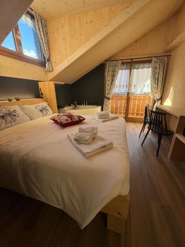 ein Schlafzimmer mit einem großen weißen Bett im Dachgeschoss in der Unterkunft Appartamenti Casa Sabry in San Niccolò Comèlico