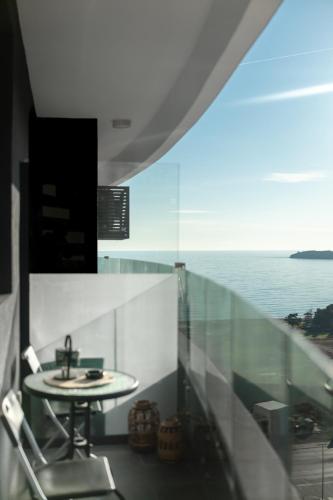 a bathroom with a sink and a view of the ocean at The Dream Getaway SkyLine by DeVasco in Bečići