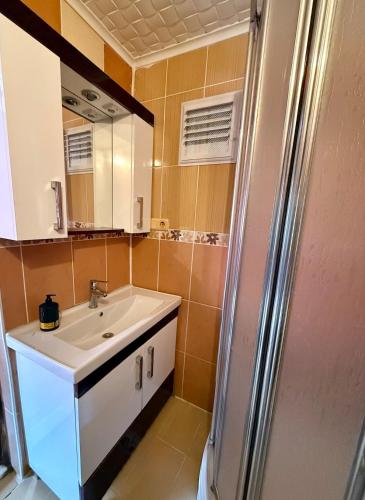 a bathroom with a sink and a refrigerator at Isgobya Sumela Monastery 104 in Macka