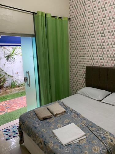 a bedroom with a bed with two towels on it at Mar & Mar Suites in Arraial do Cabo