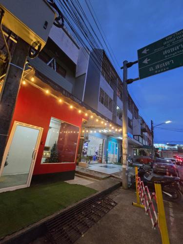 a red building with a street sign in front of it at SridaHouse#Near Central Festival Hatyai in Hat Yai