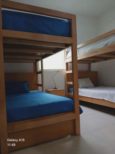 a bedroom with two bunk beds with blue sheets at Casa Pé di Polon holiday home in Picos