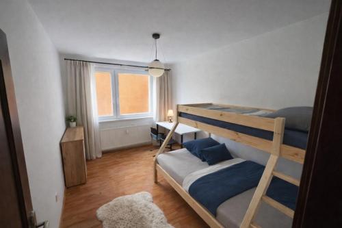 a bedroom with two bunk beds and a window at 3BR near Center with Parking in Bratislava