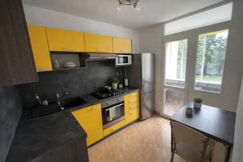a kitchen with yellow cabinets and a counter top at 3BR near Center with Parking in Bratislava