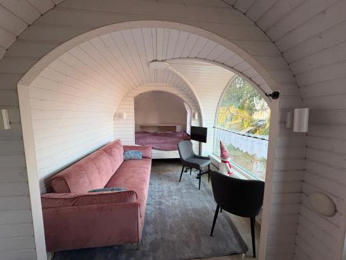 a living room with a couch and a bedroom at Seeperle Weißenstadt Haus Kornberg in Weißenstadt