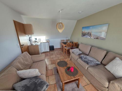 a living room with a couch and a table at Fewo LucGa in Zingst