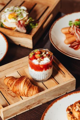 a table topped with plates of food and pastries at Hotel Ďumbier in Brezno
