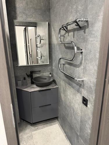a bathroom with a sink and a shower at Turgaus 10 in Klaipėda