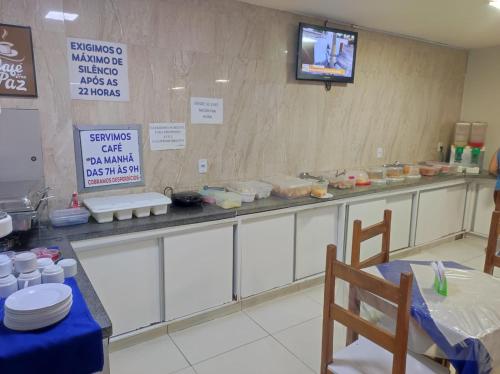 a kitchen with a counter with food on it at Estrela de davi in Goiânia