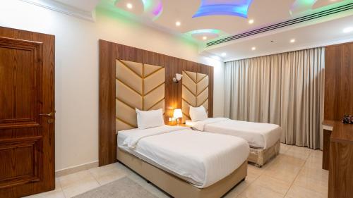 Postel nebo postele na pokoji v ubytování شقق المتألق الحديثة الفندقية