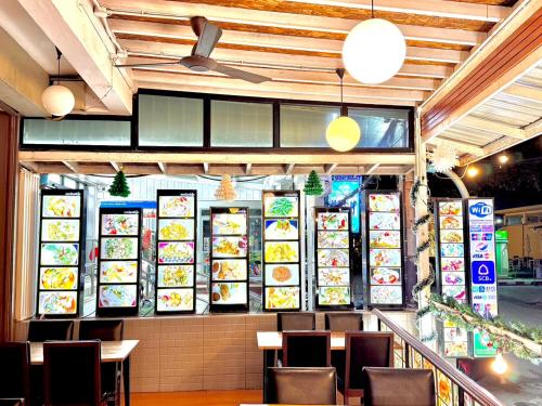 a restaurant with plates of food on the wall at Kata Noi Bay Inn in Kata Beach