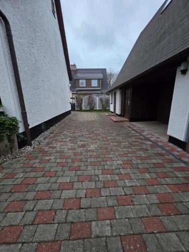 a brick driveway leading to a building at Fewo LucGa in Zingst