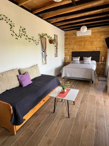 a bedroom with two beds and a table at Lofth house in Piriápolis
