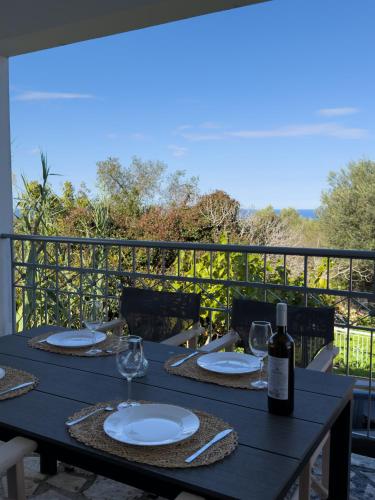 a black table with glasses and a bottle of wine at Artemis Villa in Fiskardo