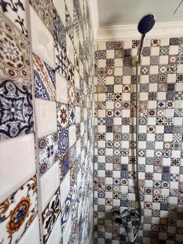 a bathroom with a shower with tiles on the wall at Isgobya Sumela Monastery 106 in Macka