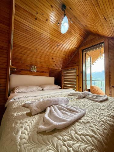 a bedroom with a large bed with towels on it at Isgobya Sumela Monastery 106 in Macka