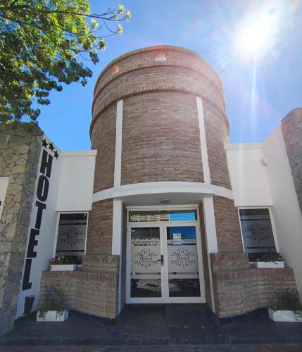 a brick building with a water tower at Hotel Portal Norte Neuquino in Chos Malal