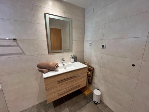 a bathroom with a sink and a mirror at Appart Leni in Pfunds