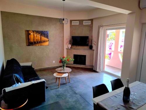 a living room with a couch and a table at Andreas' Guest House in Káto Spílaion