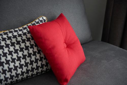 two pillows sitting on top of a couch at The Originals Boutique, Hôtel Le Pariou, Issoire in Issoire