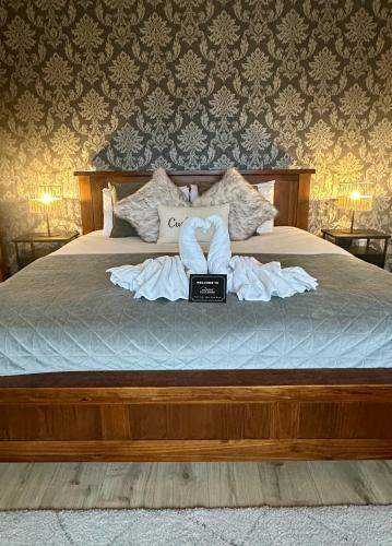 a bedroom with a bed with a laptop on it at Malahide Guest Rooms in Malahide