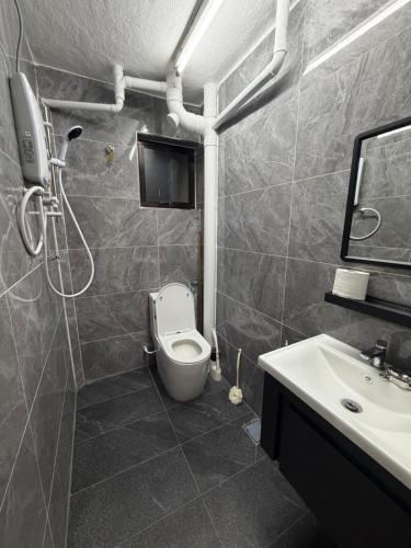 a bathroom with a toilet and a sink at Kuala Terla Cameron Cozy Home - Self Check-in in Kampung Kuala Terla