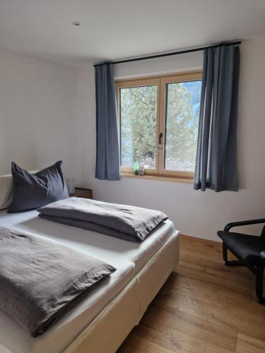 a bedroom with a bed and a window at Haus Robi Wood in Bad Kleinkirchheim