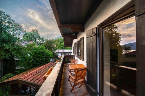 ein Balkon mit Stühlen und einem Tisch auf einem Gebäude in der Unterkunft Ferienwohnung "Hochfeld Seeblick" in Tegernsee