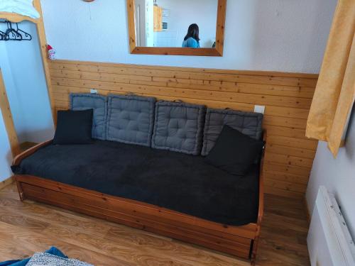 a bed in a room with a woman in a mirror at Chamrousse - Résidence La Grive in Chamrousse