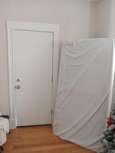 a white door with a white sheet over it at Shared Salem Apt for staying in a bed in Salem