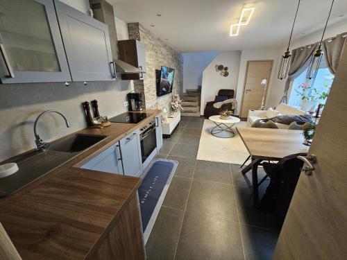 een keuken met een wastafel en een tafel in een kamer bij Ferienhaus Neunkirchen-Daun in Daun