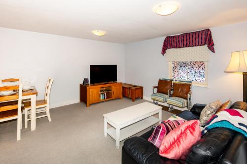 a living room with a couch and a table at Glastonbury Centre 2 Bed with on street Parking in Glastonbury
