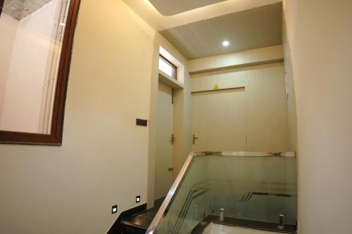 a room with a glass window and a door at Apna Ghar in Jaipur