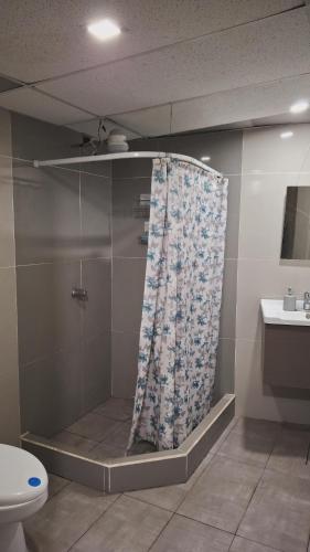 a shower curtain in a bathroom with a toilet at Casa Mary in Panajachel