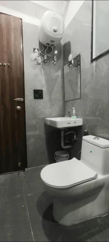 a bathroom with a toilet and a sink at Saran Homestay in Agra